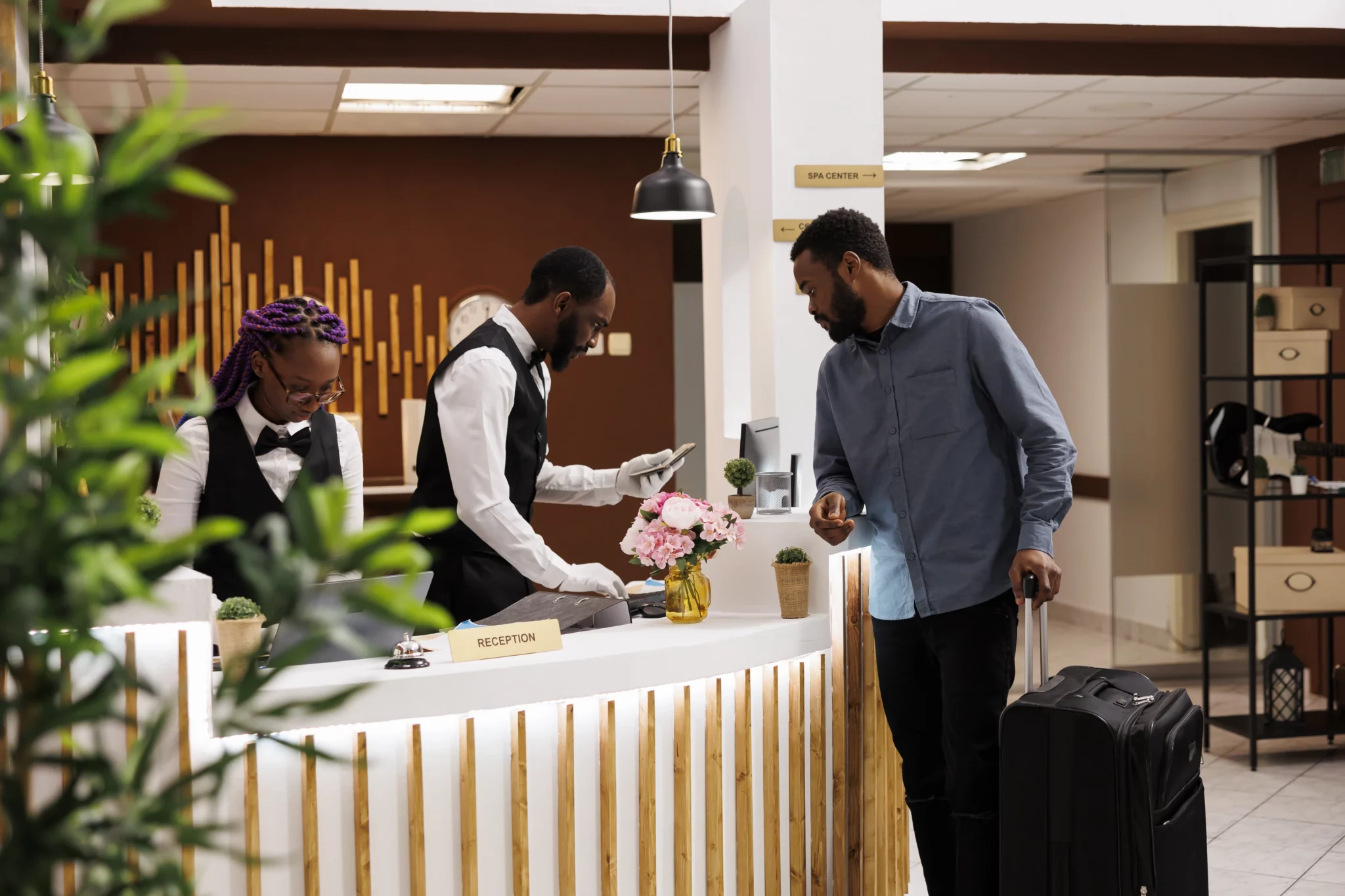 Receptionist checking guest passport